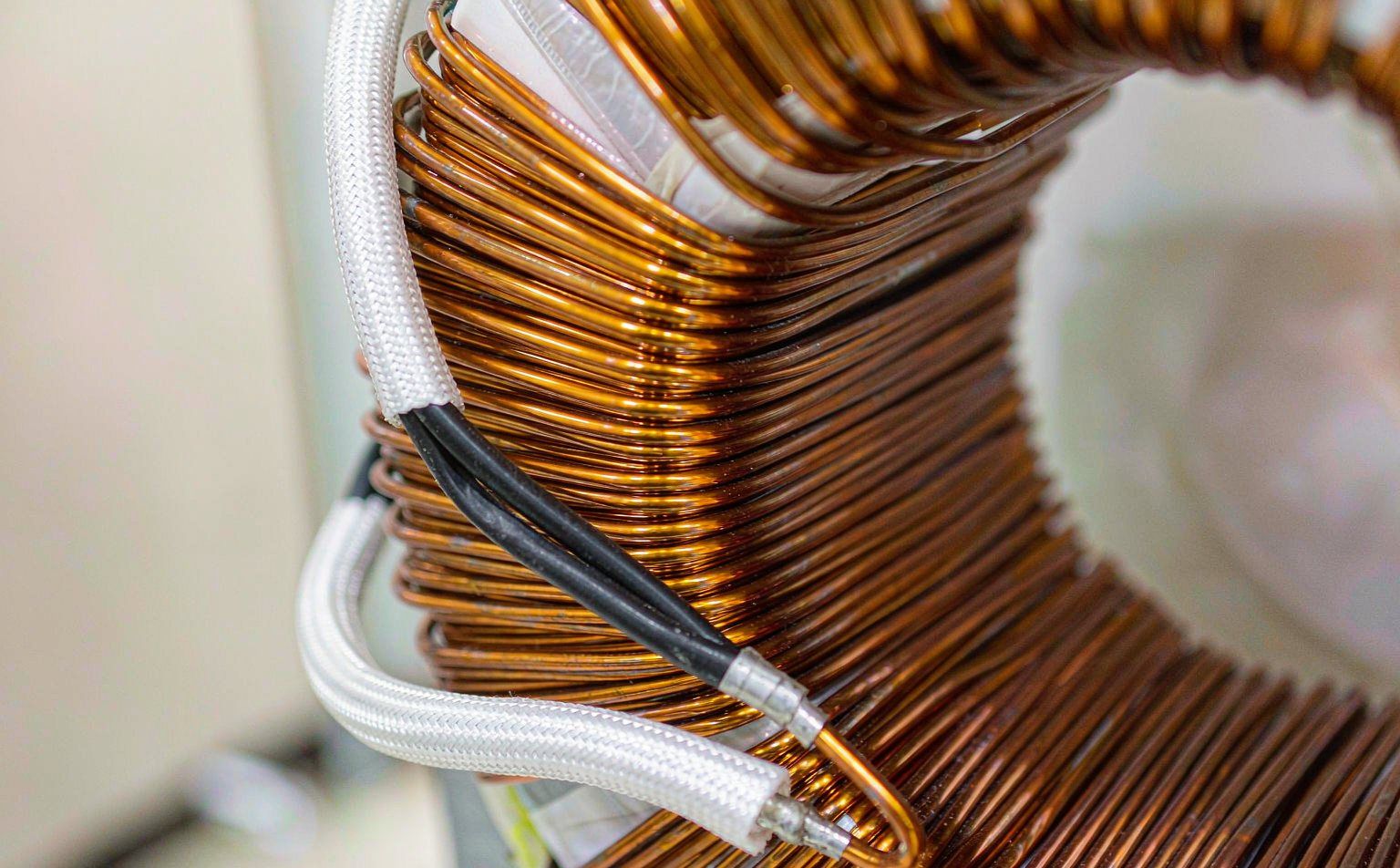 Transformer copper coil windings with lead wires insulated by white braided fiberglass sleeving